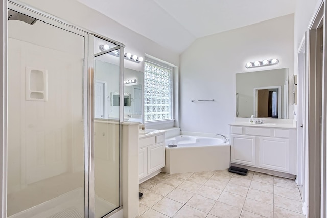 18115 Linden Forest Ln, Katy, TX 77449 - full bathroom featuring lofted ceiling, a shower stall, a bath, two vanities, and tile patterned flooring