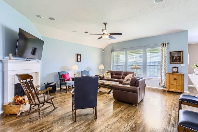 18115 Linden Forest Ln, Katy, TX 77449 - living room with wood finished floors, a ceiling fan, vaulted ceiling, and a fireplace