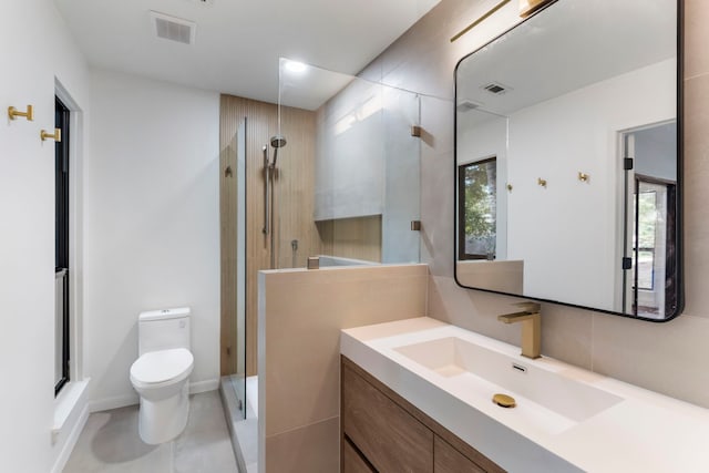 full bathroom with a shower stall, toilet, and vanity