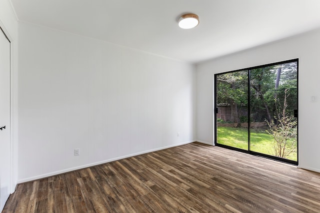 spare room with wood finished floors and baseboards