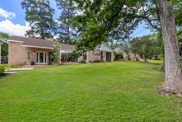 view of grassy yard featuring central AC unit