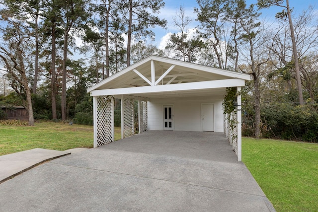 garage with concrete driveway and a carport