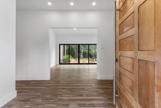 hall with baseboards, dark wood-style flooring, and recessed lighting