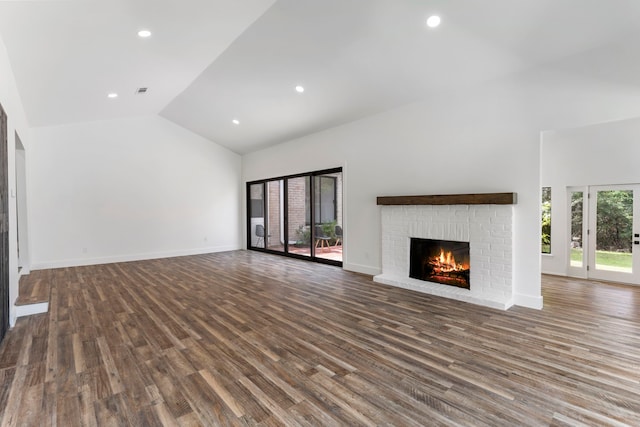 unfurnished living room featuring high vaulted ceiling, a fireplace, wood finished floors, recessed lighting, and baseboards
