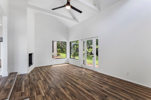 unfurnished living room with high vaulted ceiling, a fireplace, wood finished floors, a ceiling fan, and baseboards