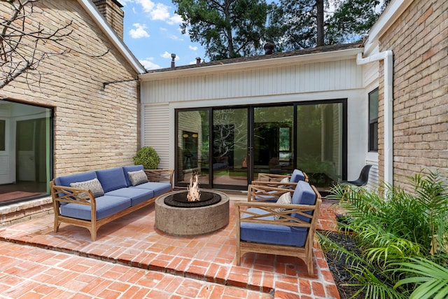 view of patio / terrace with an outdoor living space with a fire pit