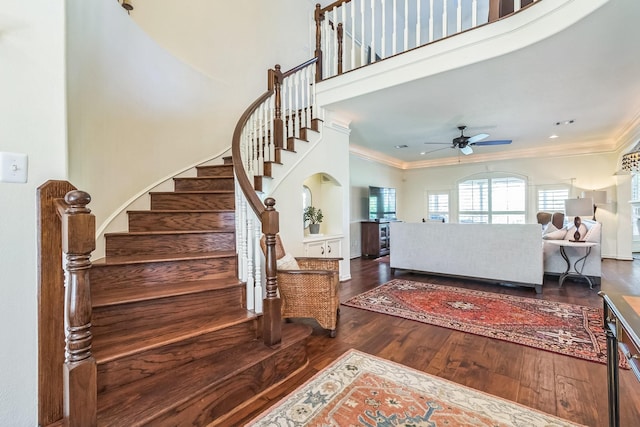 147 Sunnyvale W, Montgomery, TX 77356 - foyer entrance featuring stairway, ceiling fan, wood finished floors, ornamental molding, and a towering ceiling