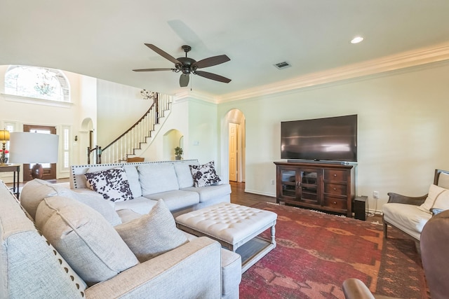 147 Sunnyvale W, Montgomery, TX 77356 - living area with arched walkways, stairway, a ceiling fan, ornamental molding, and baseboards