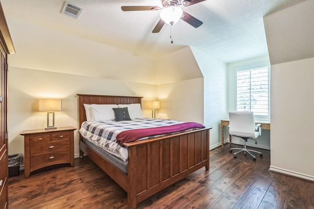 147 Sunnyvale W, Montgomery, TX 77356 - bedroom featuring dark wood finished floors, lofted ceiling, a textured ceiling, and a ceiling fan