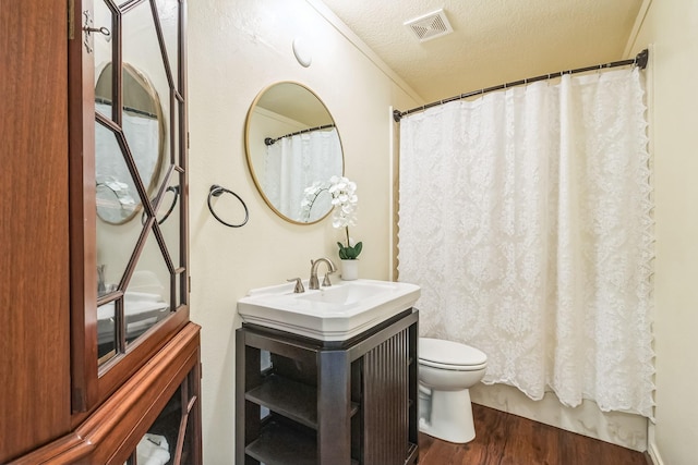 147 Sunnyvale W, Montgomery, TX 77356 - full bath with wood finished floors, toilet, a textured ceiling, vanity, and curtained shower