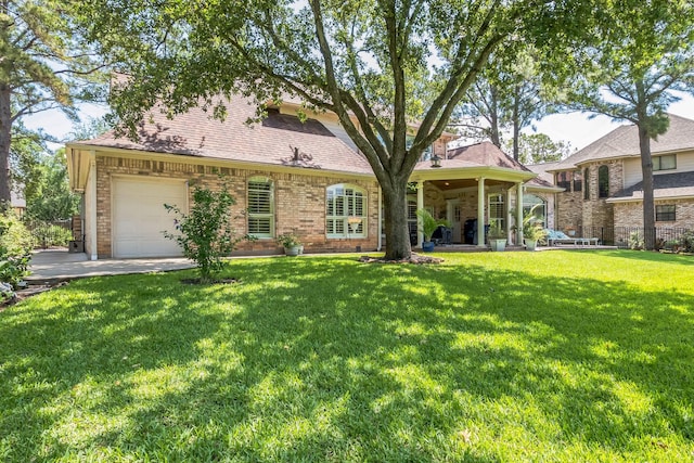 147 Sunnyvale W, Montgomery, TX 77356 - view of front of property featuring a front yard, driveway, an attached garage, and brick siding
