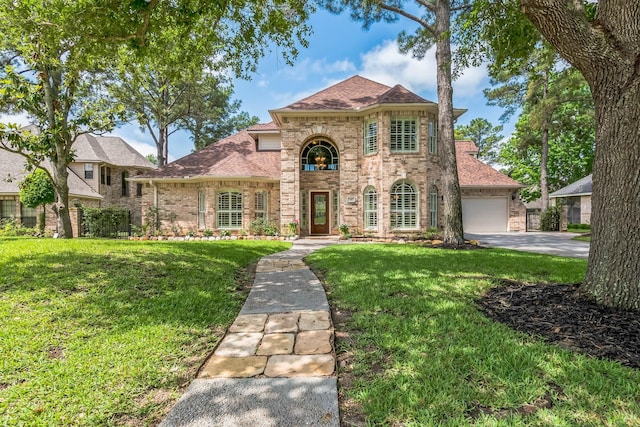 147 Sunnyvale W, Montgomery, TX 77356 - view of front of house with brick siding, a front yard, a shingled roof, and asphalt driveway