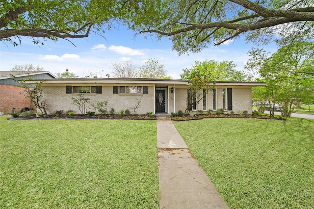 ranch-style home with brick siding and a front lawn