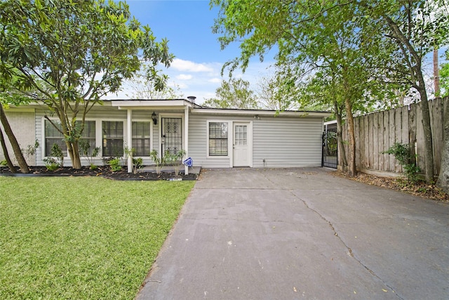 view of front facade with driveway and a gate