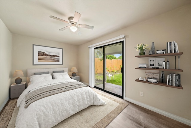 bedroom featuring access to exterior, baseboards, wood finished floors, and ceiling fan