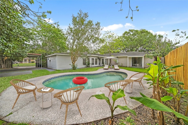 view of pool with a patio and fence