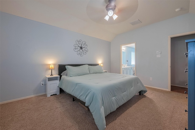 carpeted bedroom featuring vaulted ceiling, baseboards, connected bathroom, and a ceiling fan