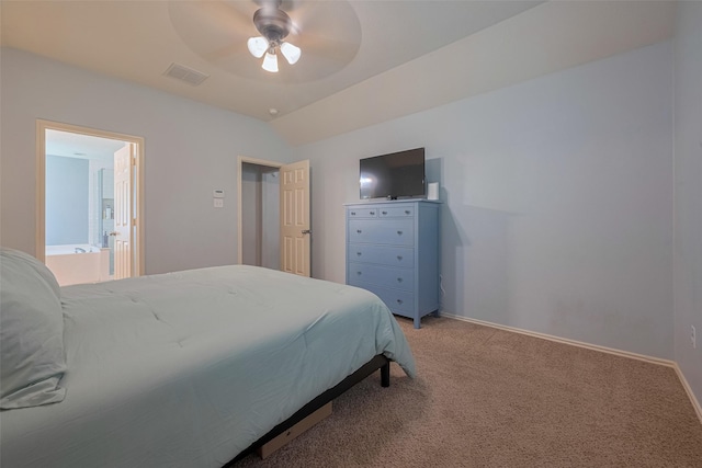 bedroom with light colored carpet, baseboards, ceiling fan, lofted ceiling, and connected bathroom