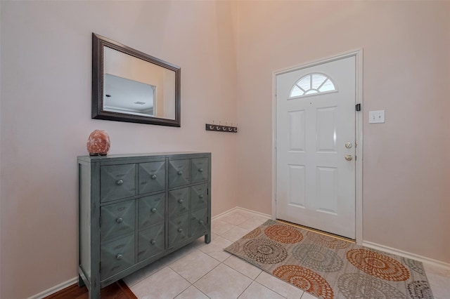 entrance foyer featuring light tile patterned floors and baseboards
