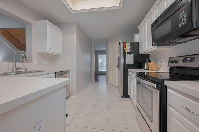 kitchen featuring appliances with stainless steel finishes, a sink, light countertops, and white cabinets