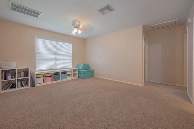 recreation room featuring carpet, a ceiling fan, baseboards, and attic access