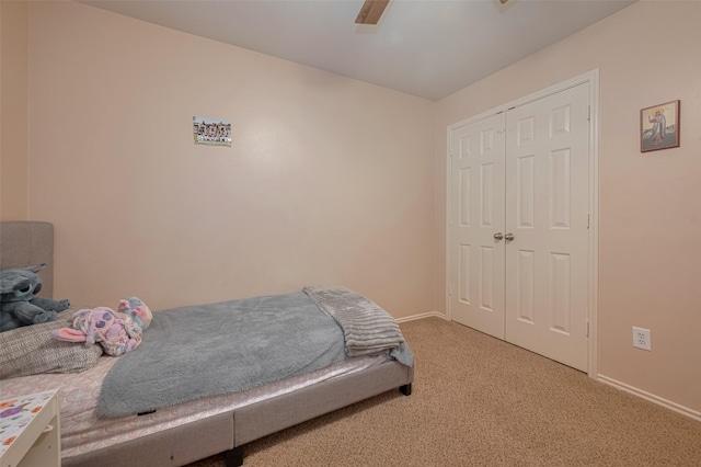 bedroom featuring carpet, baseboards, a closet, and ceiling fan