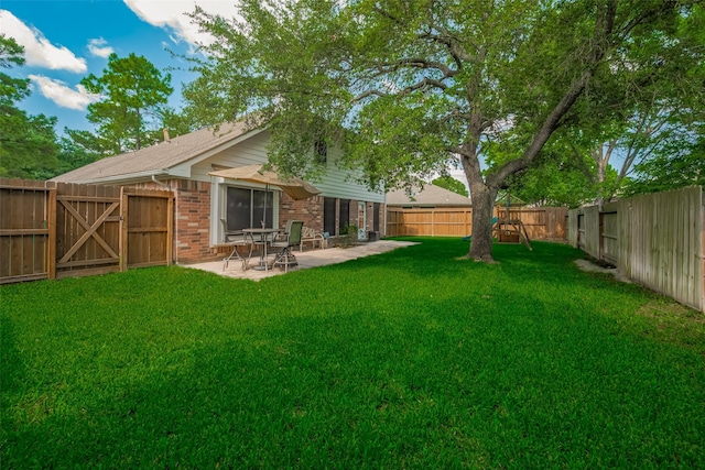 back of house with a patio area, brick siding, and a gate