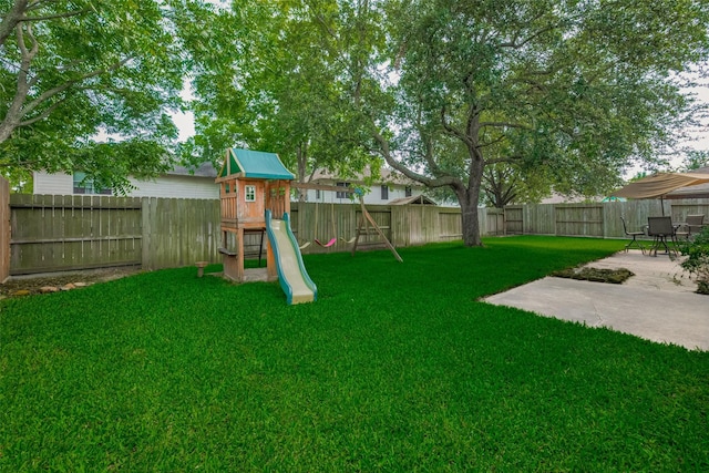 view of yard with a patio and a playground