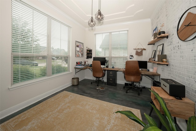 office area with healthy amount of natural light, crown molding, baseboards, and brick wall