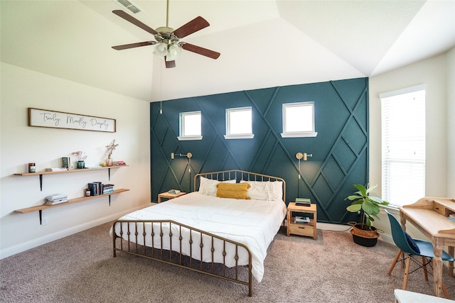 bedroom featuring vaulted ceiling, carpet flooring, baseboards, a skylight, and ceiling fan