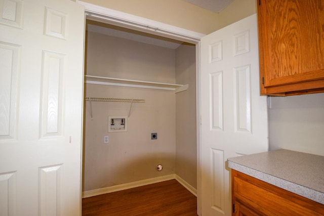 laundry room with washer hookup, hookup for an electric dryer, dark wood-style flooring, and baseboards