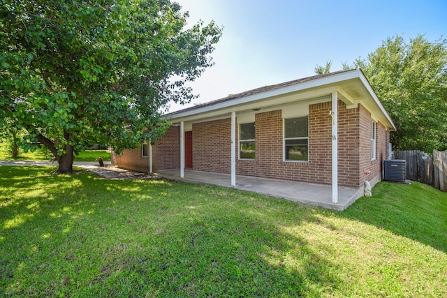 view of home's exterior featuring central AC, a patio, and brick siding