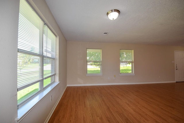 unfurnished room featuring wood finished floors and baseboards