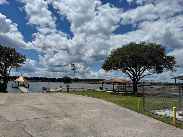 view of patio featuring a gazebo and a water view