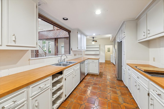 kitchen featuring a sink, stainless steel appliances, wooden counters, ceiling fan, and recessed lighting