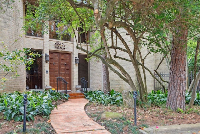 property entrance featuring brick siding