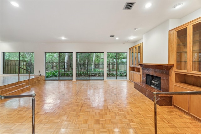 unfurnished living room featuring a fireplace, recessed lighting, and plenty of natural light