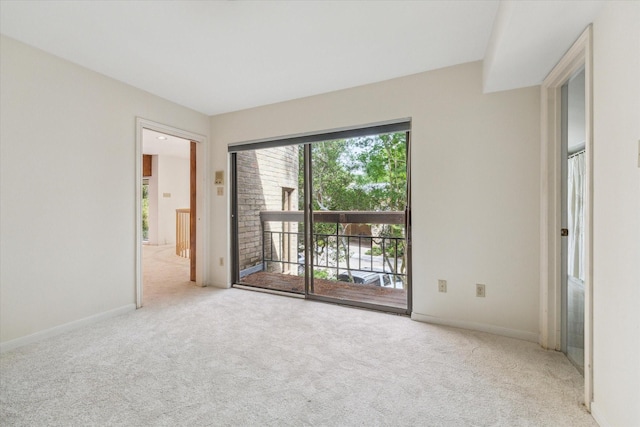 spare room featuring carpet and baseboards