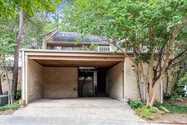 view of parking / parking lot featuring driveway and a carport