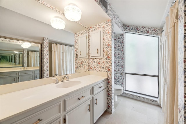 full bathroom with wallpapered walls, toilet, and vanity