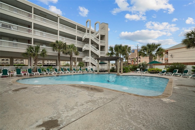 6102 Seawall Blvd Unit 290, Galveston, TX 77551 - community pool with a patio and fence