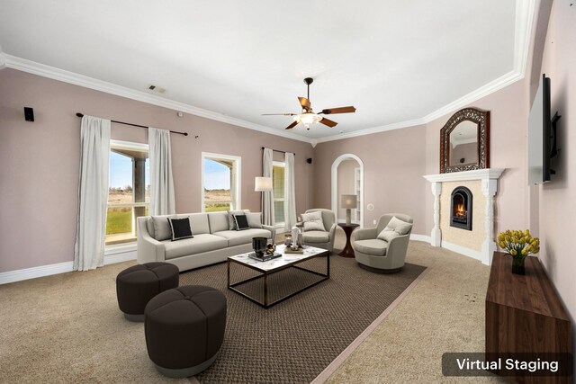 4343 Schlipf Rd, Katy, TX 77493 - carpeted living room with ornamental molding, ceiling fan, a warm lit fireplace, baseboards, and arched walkways