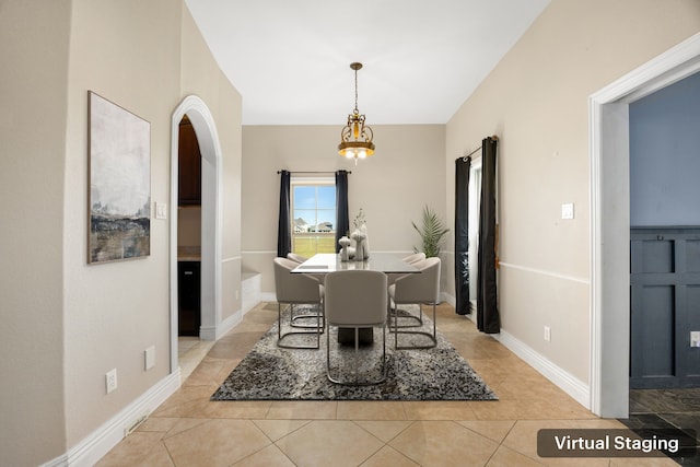 4343 Schlipf Rd, Katy, TX 77493 - dining area with arched walkways, light tile patterned flooring, and baseboards