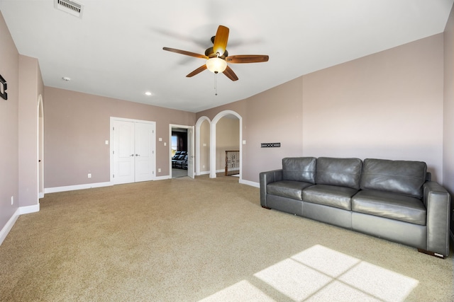 4343 Schlipf Rd, Katy, TX 77493 - living room featuring arched walkways, carpet, a ceiling fan, baseboards, and recessed lighting
