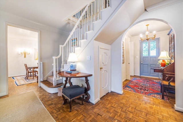 7603 Olympia Dr, Houston, TX 77063 - foyer entrance featuring arched walkways, a chandelier, ornamental molding, stairs, and baseboards