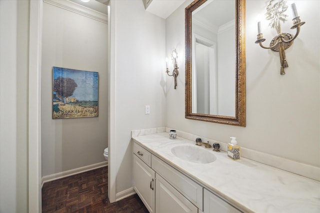 7603 Olympia Dr, Houston, TX 77063 - bathroom featuring vanity, ornamental molding, baseboards, and toilet