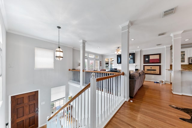 1708 Wilson St, Houston, TX 77019 - corridor featuring ornate columns, an upstairs landing, wood finished floors, crown molding, and recessed lighting