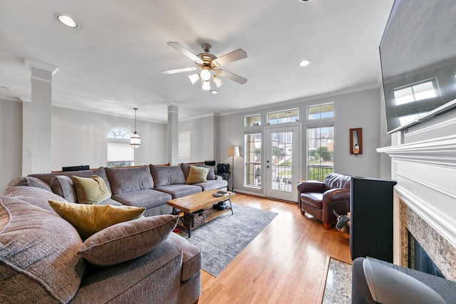 1708 Wilson St, Houston, TX 77019 - living area featuring ornate columns, plenty of natural light, ceiling fan, crown molding, and recessed lighting