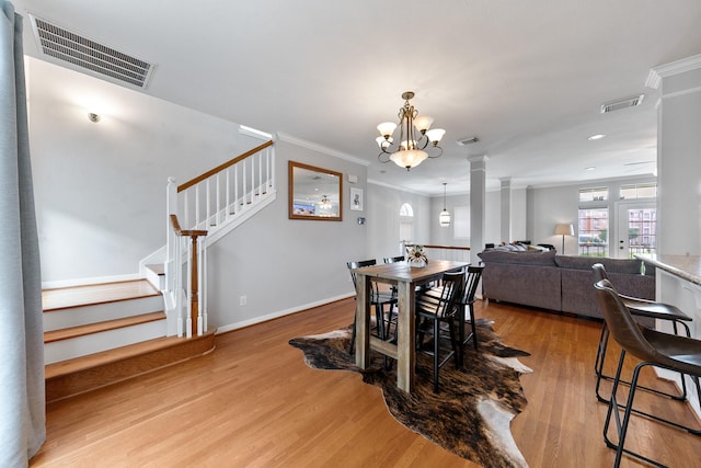 1708 Wilson St, Houston, TX 77019 - dining room featuring wood finished floors, a chandelier, ornamental molding, stairway, and baseboards