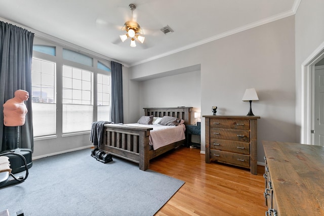 1708 Wilson St, Houston, TX 77019 - bedroom featuring crown molding, baseboards, light wood finished floors, and ceiling fan
